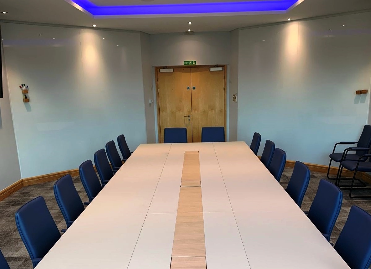 Rectangular boardroom table with writable glass panels