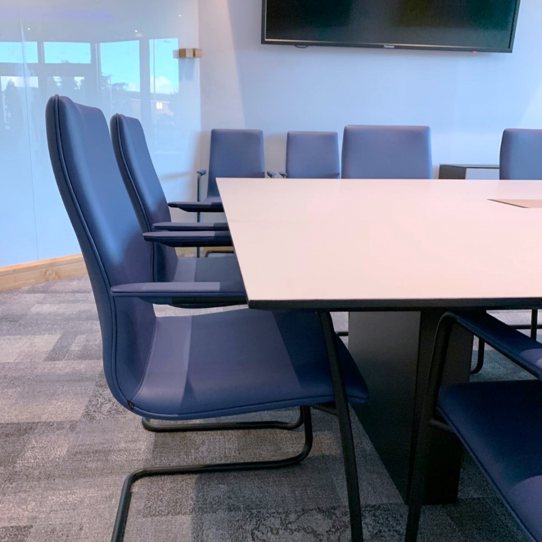 Blue chairs around a boardroom table